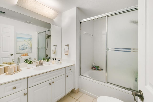 2916 Tuscany Ct Unit 104, Palm Beach Gardens, FL 33410 - full bathroom with vanity, bath / shower combo with glass door, tile patterned floors, and toilet
