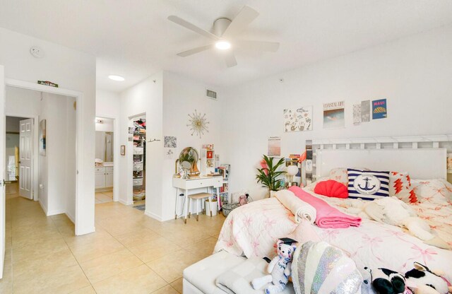 2916 Tuscany Ct Unit 104, Palm Beach Gardens, FL 33410 - bedroom with light tile patterned floors, ensuite bath, a ceiling fan, and baseboards