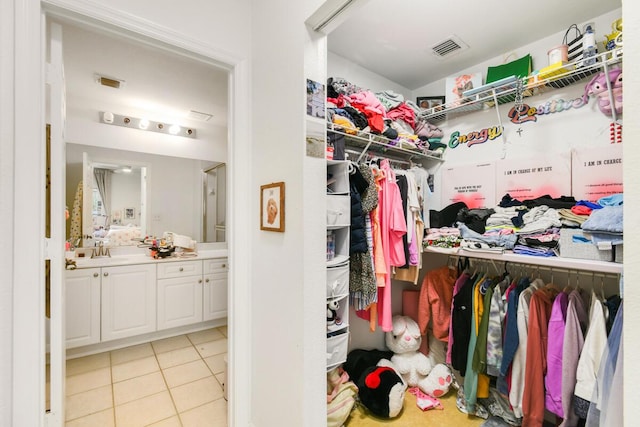 2916 Tuscany Ct Unit 104, Palm Beach Gardens, FL 33410 - walk in closet featuring a sink and light tile patterned floors