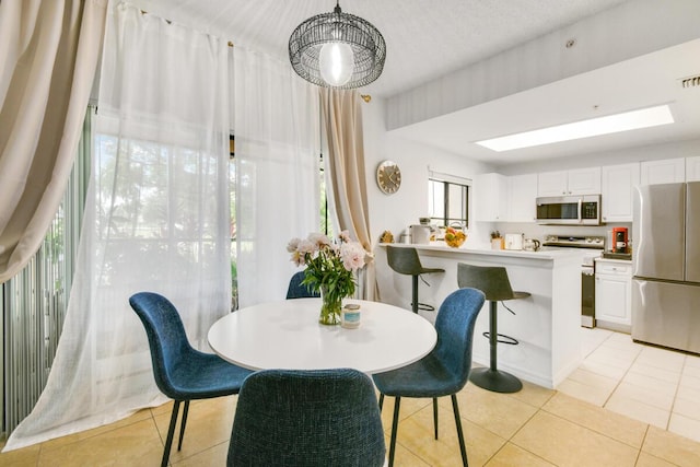 2916 Tuscany Ct Unit 104, Palm Beach Gardens, FL 33410 - dining room with light tile patterned flooring and healthy amount of natural light