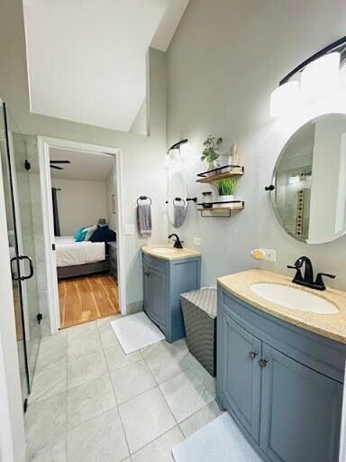 7624 Pinewalk Dr S Unit 147, Margate, FL 33063 - bathroom with a shower stall, two vanities, tile patterned flooring, lofted ceiling, and ensuite bath