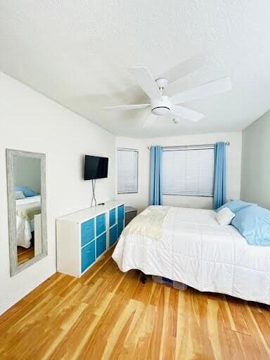7624 Pinewalk Dr S Unit 147, Margate, FL 33063 - bedroom featuring light wood-type flooring, a ceiling fan, and a textured ceiling
