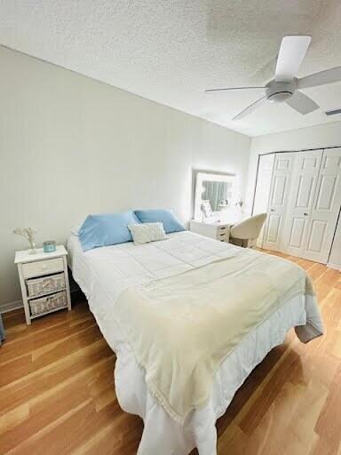 7624 Pinewalk Dr S Unit 147, Margate, FL 33063 - bedroom featuring light wood finished floors, a closet, a ceiling fan, and a textured ceiling