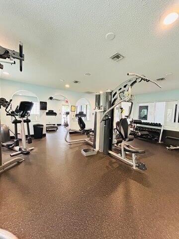 7624 Pinewalk Dr S Unit 147, Margate, FL 33063 - gym featuring a textured ceiling and healthy amount of natural light
