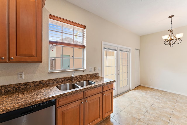 128 W Thatch Palm Cir, Jupiter, FL 33458 - kitchen with a sink, stainless steel dishwasher, brown cabinets, and decorative light fixtures