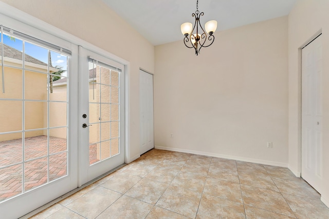 128 W Thatch Palm Cir, Jupiter, FL 33458 - unfurnished dining area with a chandelier, french doors, light tile patterned floors, and baseboards