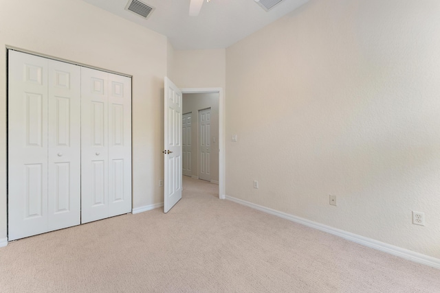 128 W Thatch Palm Cir, Jupiter, FL 33458 - unfurnished bedroom featuring light colored carpet, baseboards, a closet, and a ceiling fan