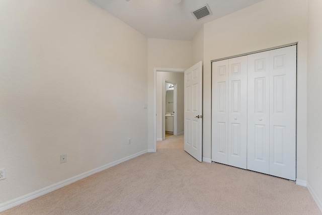 128 W Thatch Palm Cir, Jupiter, FL 33458 - unfurnished bedroom with light colored carpet, baseboards, and a closet