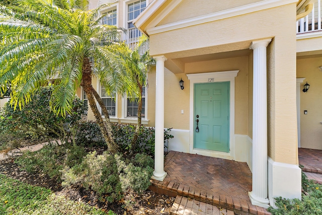 128 W Thatch Palm Cir, Jupiter, FL 33458 - doorway to property featuring stucco siding