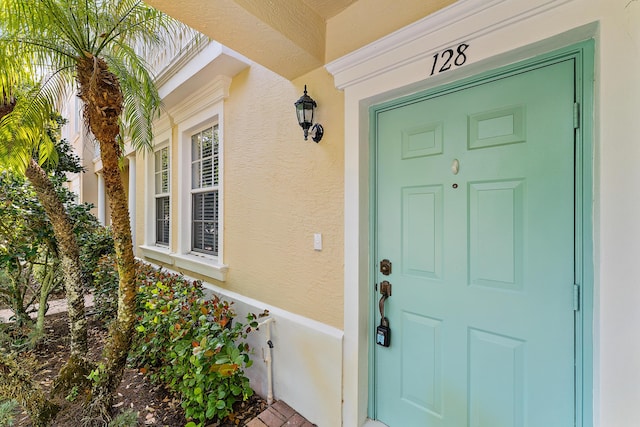 128 W Thatch Palm Cir, Jupiter, FL 33458 - entrance to property featuring stucco siding