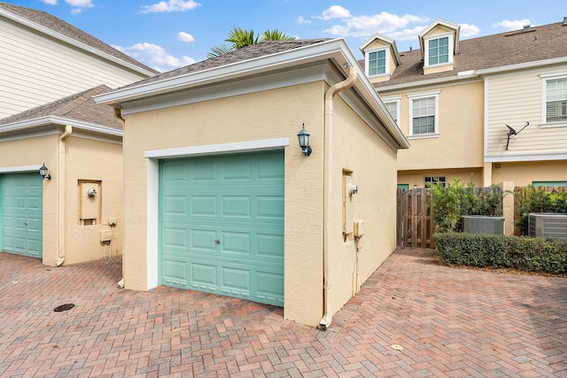 128 W Thatch Palm Cir, Jupiter, FL 33458 - garage with central air condition unit and decorative driveway