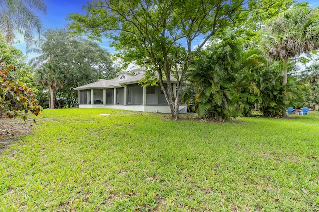 17069 81st Ln N, Loxahatchee, FL 33470 - view of green lawn featuring a sunroom