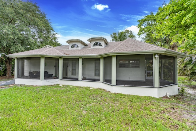 17069 81st Ln N, Loxahatchee, FL 33470 - rear view of property featuring a sunroom, a lawn, and roof with shingles