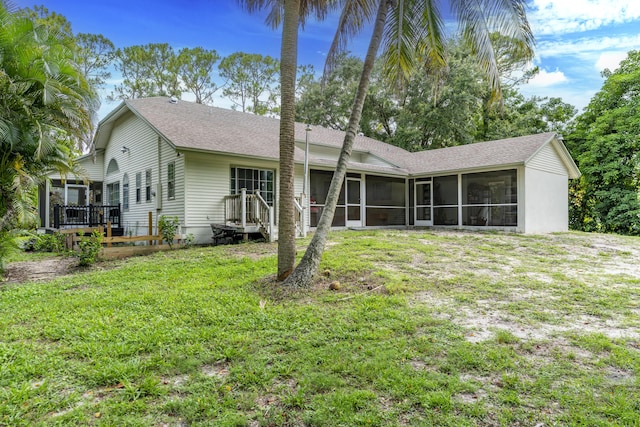 17069 81st Ln N, Loxahatchee, FL 33470 - rear view of house featuring a sunroom, a wooden deck, a lawn, and a shingled roof