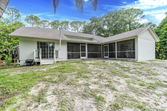 17069 81st Ln N, Loxahatchee, FL 33470 - rear view of property with a sunroom and a shingled roof