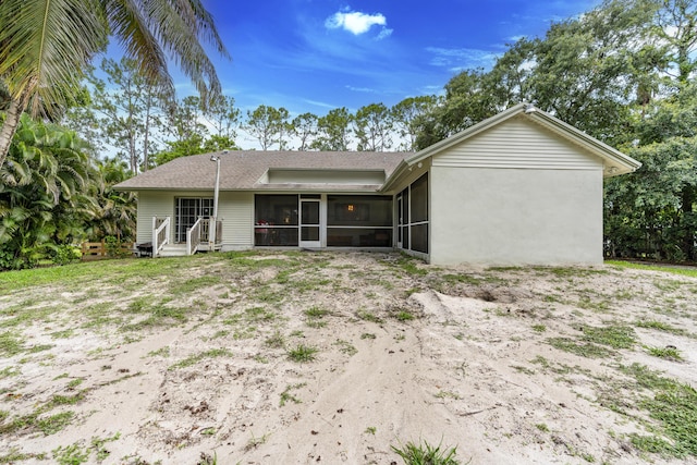 17069 81st Ln N, Loxahatchee, FL 33470 - rear view of property with a sunroom and a shingled roof