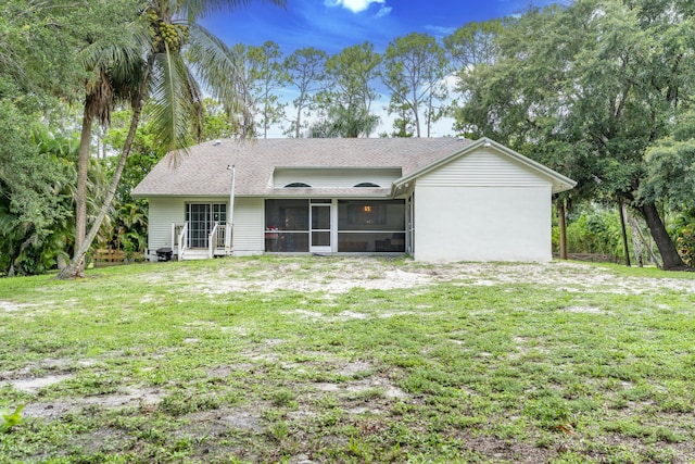 17069 81st Ln N, Loxahatchee, FL 33470 - back of house with a sunroom, a yard, and roof with shingles