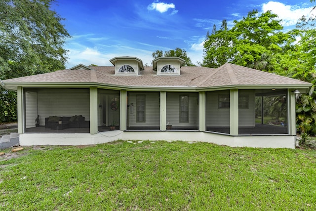 17069 81st Ln N, Loxahatchee, FL 33470 - back of property featuring a shingled roof, a sunroom, and a lawn