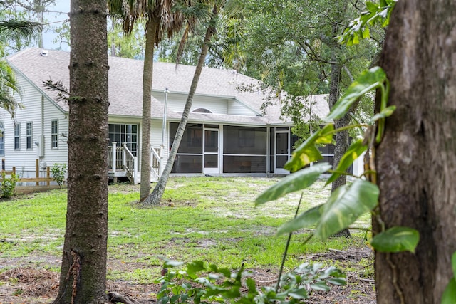 17069 81st Ln N, Loxahatchee, FL 33470 - rear view of house featuring roof with shingles and a sunroom
