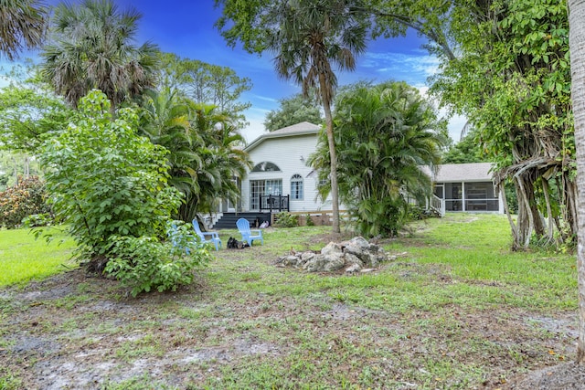 17069 81st Ln N, Loxahatchee, FL 33470 - view of green lawn with a sunroom
