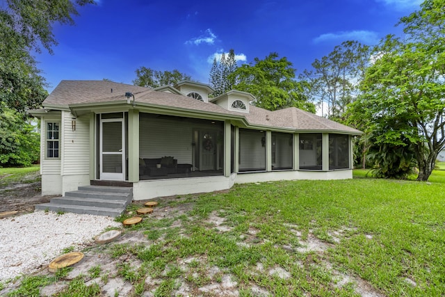 17069 81st Ln N, Loxahatchee, FL 33470 - back of house featuring a sunroom, a yard, roof with shingles, and entry steps
