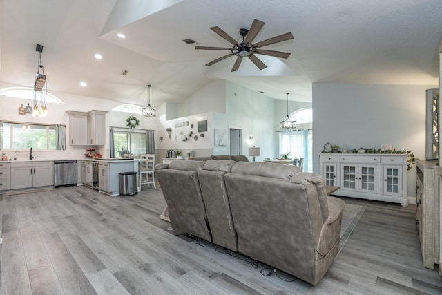 17069 81st Ln N, Loxahatchee, FL 33470 - living area with a ceiling fan, a chandelier, light wood finished floors, recessed lighting, and high vaulted ceiling