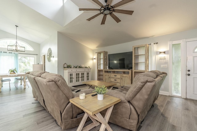 17069 81st Ln N, Loxahatchee, FL 33470 - living area featuring lofted ceiling, light wood-style flooring, ceiling fan, and a chandelier