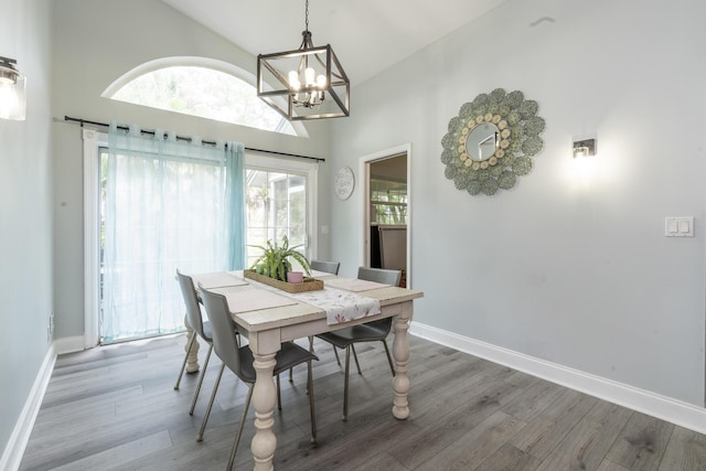 17069 81st Ln N, Loxahatchee, FL 33470 - dining room with a chandelier, plenty of natural light, wood finished floors, and high vaulted ceiling