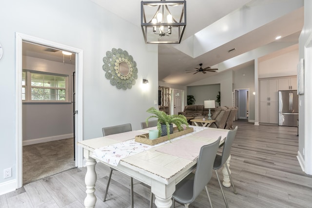 17069 81st Ln N, Loxahatchee, FL 33470 - dining area featuring a chandelier, light wood-type flooring, baseboards, a ceiling fan, and vaulted ceiling