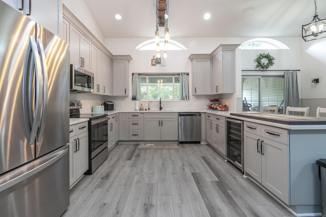 17069 81st Ln N, Loxahatchee, FL 33470 - kitchen with stainless steel appliances, a chandelier, beverage cooler, a peninsula, and a sink