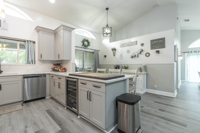 17069 81st Ln N, Loxahatchee, FL 33470 - kitchen with dishwasher, beverage cooler, a peninsula, lofted ceiling, and a wainscoted wall
