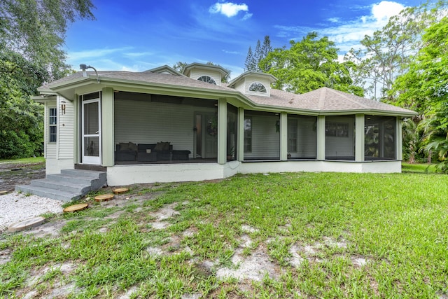 17069 81st Ln N, Loxahatchee, FL 33470 - back of house with a sunroom, entry steps, a lawn, and a shingled roof