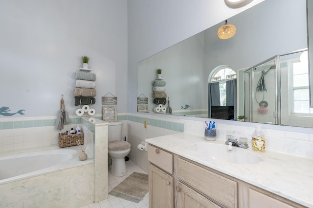 17069 81st Ln N, Loxahatchee, FL 33470 - bathroom with tile patterned flooring, a bath, a shower stall, vanity, and toilet