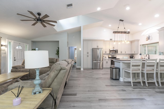17069 81st Ln N, Loxahatchee, FL 33470 - living area with a ceiling fan, light wood-type flooring, high vaulted ceiling, and recessed lighting