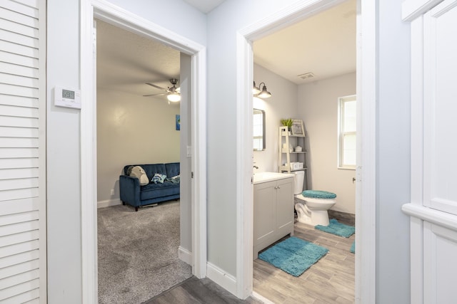 17069 81st Ln N, Loxahatchee, FL 33470 - bathroom featuring vanity, ceiling fan, wood finished floors, toilet, and baseboards