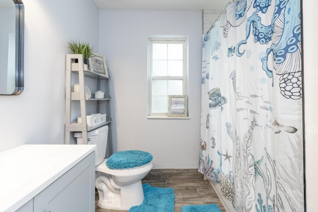 17069 81st Ln N, Loxahatchee, FL 33470 - bathroom featuring toilet, vanity, wood finish floors, and curtained shower