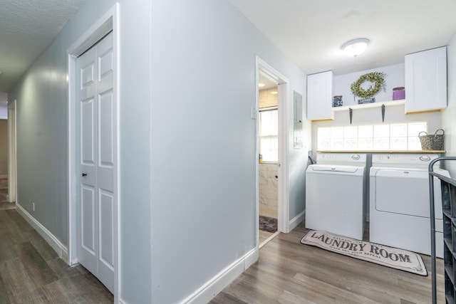 17069 81st Ln N, Loxahatchee, FL 33470 - laundry area with washing machine and clothes dryer, wood finished floors, cabinet space, baseboards, and a textured ceiling