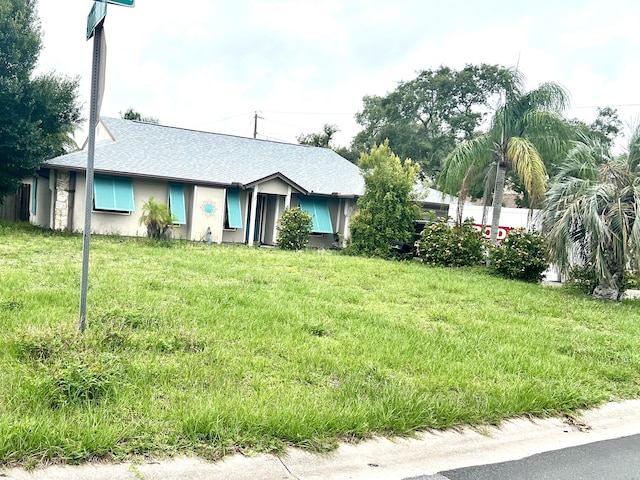 125 Capri Ave, Sebastian, FL 32958 - ranch-style house featuring a shingled roof, a front yard, and stucco siding