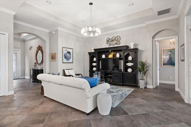 9926 SW Nuova Way, Port Saint Lucie, FL 34986 - living room with a raised ceiling, arched walkways, baseboards, a chandelier, and ornamental molding