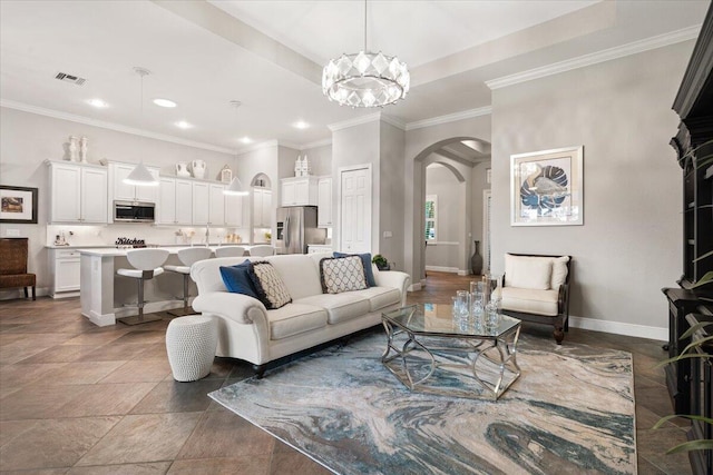 9926 SW Nuova Way, Port Saint Lucie, FL 34986 - living area with arched walkways, recessed lighting, baseboards, crown molding, and a chandelier