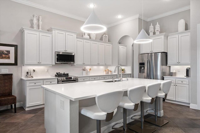 9926 SW Nuova Way, Port Saint Lucie, FL 34986 - kitchen featuring appliances with stainless steel finishes, a sink, decorative backsplash, a center island with sink, and white cabinets