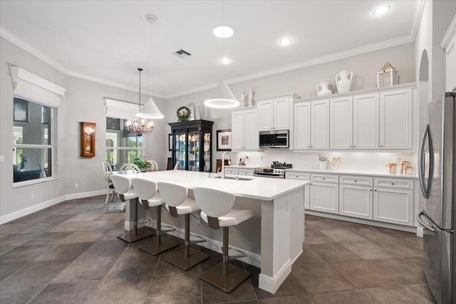 9926 SW Nuova Way, Port Saint Lucie, FL 34986 - kitchen featuring stainless steel appliances, a sink, a breakfast bar, white cabinetry, and ornamental molding
