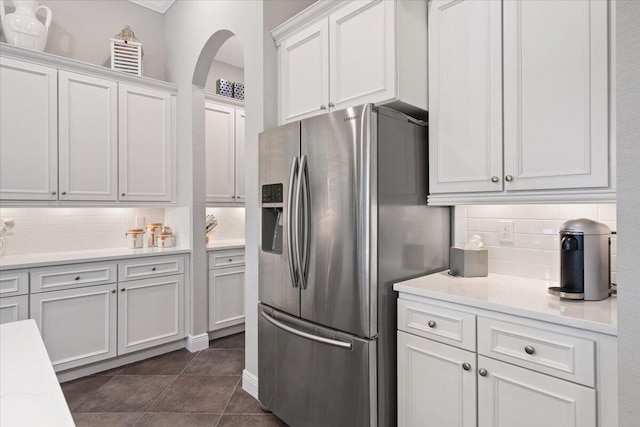 9926 SW Nuova Way, Port Saint Lucie, FL 34986 - kitchen with stainless steel fridge with ice dispenser, backsplash, and white cabinets