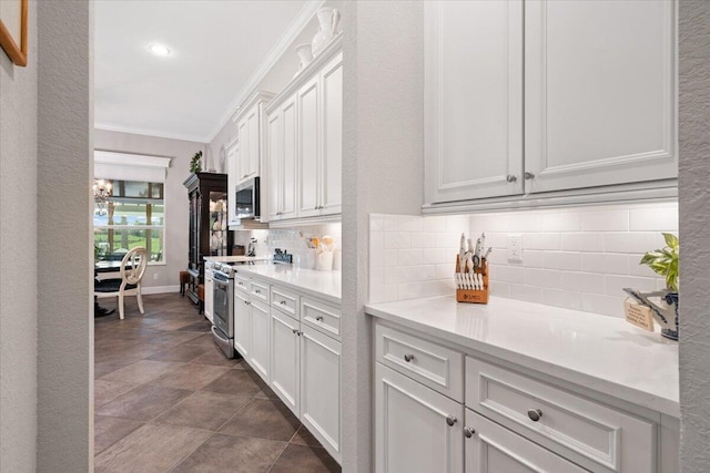 9926 SW Nuova Way, Port Saint Lucie, FL 34986 - kitchen featuring stainless steel appliances, ornamental molding, backsplash, light countertops, and white cabinets