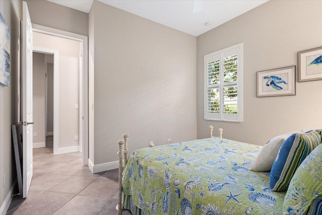 9926 SW Nuova Way, Port Saint Lucie, FL 34986 - tiled bedroom featuring baseboards