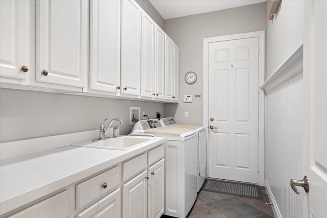 9926 SW Nuova Way, Port Saint Lucie, FL 34986 - laundry area featuring independent washer and dryer, cabinet space, and tile patterned floors