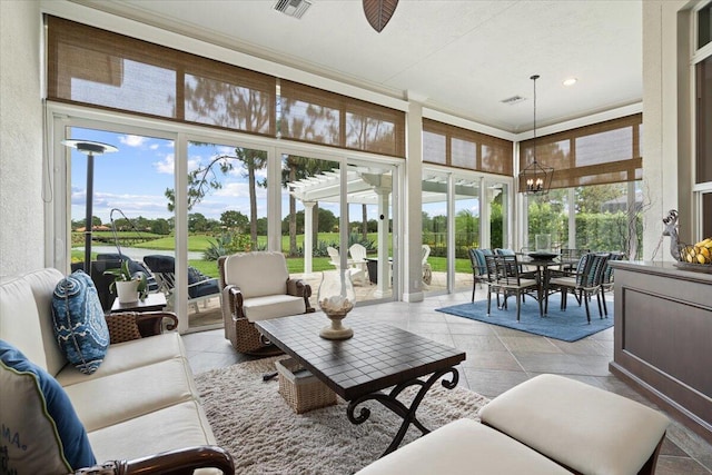 9926 SW Nuova Way, Port Saint Lucie, FL 34986 - sunroom with plenty of natural light, a chandelier, and golf course view