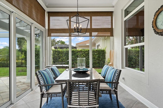 9926 SW Nuova Way, Port Saint Lucie, FL 34986 - sunroom / solarium with a textured wall, ornamental molding, a chandelier, tile patterned flooring, and baseboards