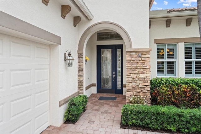 9926 SW Nuova Way, Port Saint Lucie, FL 34986 - doorway to property with a garage, stone siding, and stucco siding