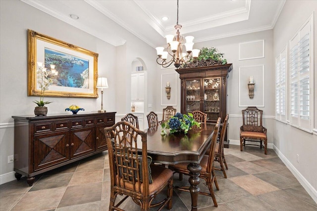 9926 SW Nuova Way, Port Saint Lucie, FL 34986 - dining area with a chandelier, a tray ceiling, crown molding, baseboards, and arched walkways